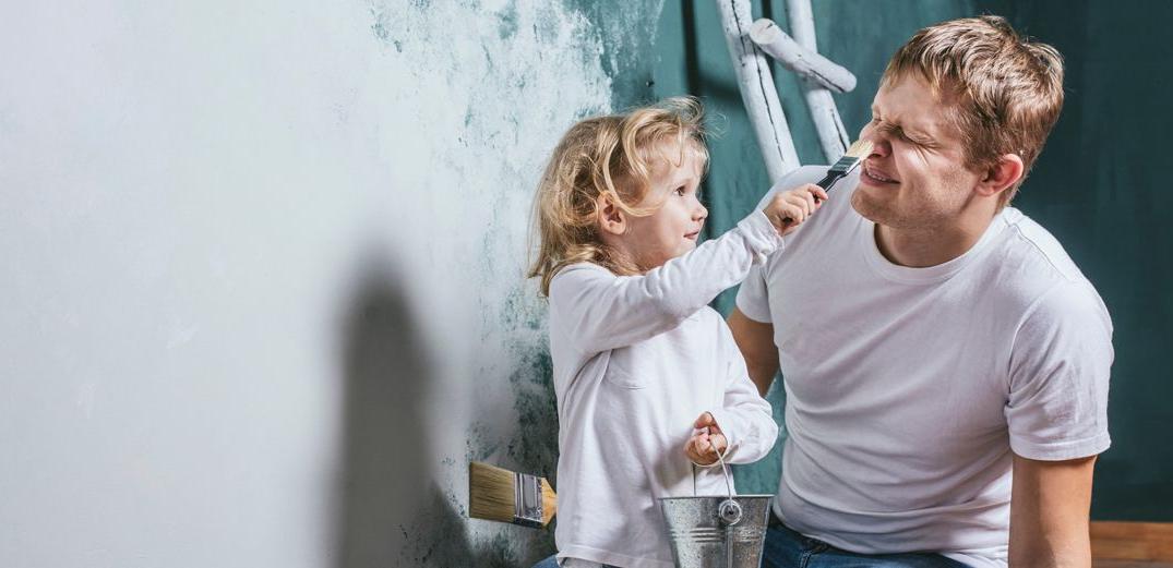 A toddler paints her dad's nose in the middle of a home improvement project funded by a home equity loan from Patelco.