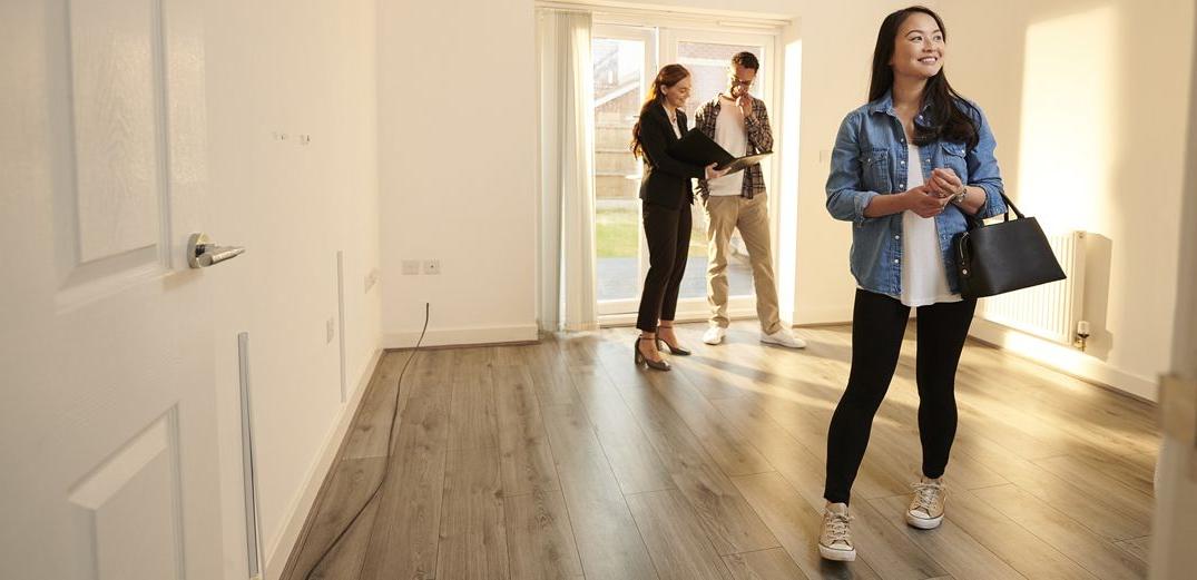 Potential homebuyers tour a house.